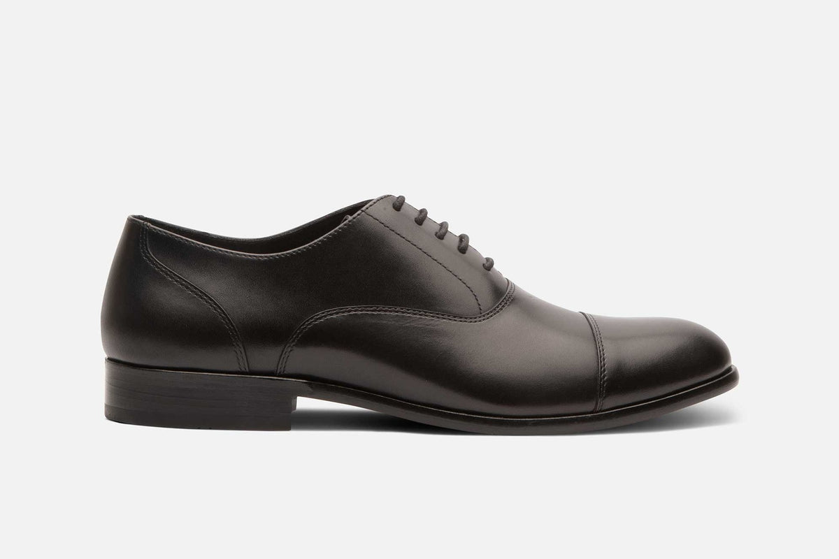The Adams cap-toe oxford in black, side profile
