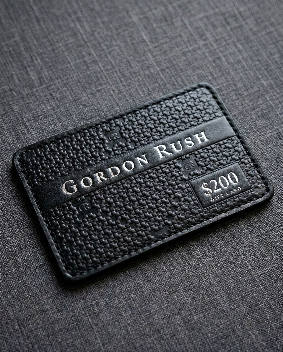 Gordon Rush digital gift card design in black calfskin with the GR lattice pressed into the leather and silver foil lettering, $200