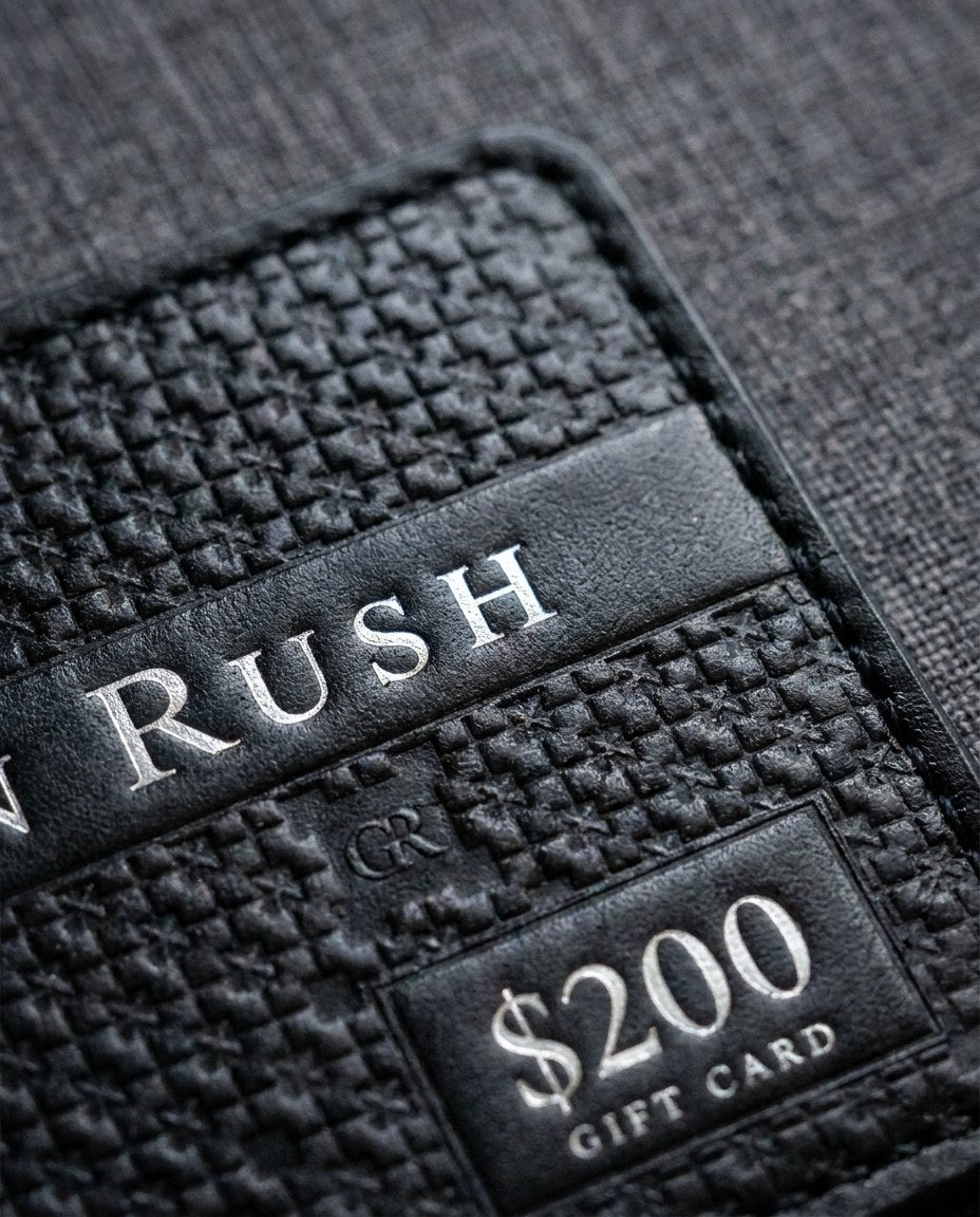 Close-up of the digital gift card design: the GR lattice heat-pressed into the leather and the Gordon Rush name in silver foil